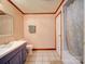 Well-lit bathroom featuring a single sink vanity, toilet, and a shower-tub combo with tile flooring at 110 Dutch Creek Rd, Rockwell, NC 28138