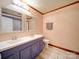 Bathroom with a double sink vanity, a toilet, a towel rack, and a mirror with tile flooring at 110 Dutch Creek Rd, Rockwell, NC 28138