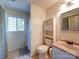 Bathroom with pink vanity, toilet, and shower-tub combo with a window at 110 Dutch Creek Rd, Rockwell, NC 28138
