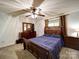 Bedroom featuring a bed with dark wood frame, matching dressers, neutral carpet, and a ceiling fan at 110 Dutch Creek Rd, Rockwell, NC 28138
