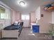 Bedroom with neutral walls and carpet, a twin bed, window, and a desk at 110 Dutch Creek Rd, Rockwell, NC 28138
