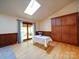 Open dining room featuring hardwood floors, ample natural light from a skylight, and built-in cabinets at 110 Dutch Creek Rd, Rockwell, NC 28138