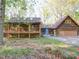Rustic cabin-style home featuring a wooden facade, raised porch, and a charming blue front door at 110 Dutch Creek Rd, Rockwell, NC 28138