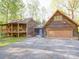 Exterior view of the rustic home showing the siding, garage and ample parking at 110 Dutch Creek Rd, Rockwell, NC 28138
