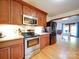 Kitchen with wood cabinets, stainless appliances, granite countertops, and an open view to the living area at 110 Dutch Creek Rd, Rockwell, NC 28138