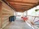 A wooden porch features a grill, a table with chairs, a door, and a view of the outdoors at 110 Dutch Creek Rd, Rockwell, NC 28138