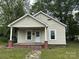 Charming single-story home with a covered front porch and a well-maintained lawn at 110 E Church St, Dallas, NC 28034