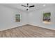 Inviting bedroom with wood-look floors, a ceiling fan, and natural light from two windows at 1119 Stanback Rd, Chester, SC 29730