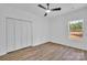 Bright bedroom features wood-look floors, a ceiling fan, and a window overlooking trees at 1119 Stanback Rd, Chester, SC 29730
