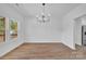 Bright dining room features wood-look floors, modern chandelier, and natural light at 1119 Stanback Rd, Chester, SC 29730