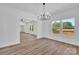 Open dining room features wood-look floors, modern chandelier, and abundant natural light at 1119 Stanback Rd, Chester, SC 29730