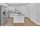 Modern kitchen features white cabinets, an island, stainless appliances and wood-look floors at 1119 Stanback Rd, Chester, SC 29730