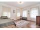 Comfortable bedroom features hardwood floors, natural light and a decorative rug at 122 Corban Se Ave, Concord, NC 28025