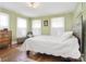 Comfortable bedroom features hardwood floors and natural light from the windows at 122 Corban Se Ave, Concord, NC 28025