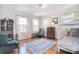 Bright bedroom with hardwood floors, two armchairs, and natural light from the windows at 122 Corban Se Ave, Concord, NC 28025