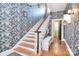 Inviting entryway features a staircase with wooden steps and unique patterned wallpaper on the walls at 122 Corban Se Ave, Concord, NC 28025