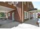 Spacious brick home with a covered porch, featuring a seating area and a well-manicured lawn at 122 Corban Se Ave, Concord, NC 28025