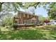 Beautiful brick home featuring a classic design, lush landscaping, and a welcoming front porch at 122 Corban Se Ave, Concord, NC 28025