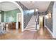 Spacious foyer with hardwood floors, staircase, and decorative wallpaper leading to other rooms at 122 Corban Se Ave, Concord, NC 28025