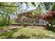 Inviting brick home with well-maintained lawn, mature trees, and a charming front porch at 122 Corban Se Ave, Concord, NC 28025