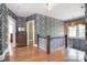 Spacious hallway features hardwood floors, patterned wallpaper and natural light from the window at 122 Corban Se Ave, Concord, NC 28025
