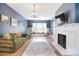Inviting living room with blue walls, fireplace, hardwood floors, and a cozy window seat at 122 Corban Se Ave, Concord, NC 28025
