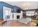 Bright and spacious living room with fireplace, French doors, hardwood floors and unique fixtures at 122 Corban Se Ave, Concord, NC 28025