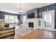 Cozy living room with a fireplace, large windows, hardwood floors and a window bench seat at 122 Corban Se Ave, Concord, NC 28025
