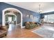 Comfortable living room with an arched doorway, dark blue walls, hardwood floors and a window seat at 122 Corban Se Ave, Concord, NC 28025