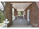 Covered porch with comfortable seating, perfect for relaxing and enjoying the outdoor view at 122 Corban Se Ave, Concord, NC 28025