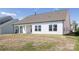 A home with white siding features a covered patio and spacious backyard, ideal for outdoor activities and relaxation at 13063 Arnold Palmer Cir # 839, Lancaster, SC 29720