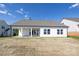 New home with a white siding and a covered patio overlooking an expansive backyard under a clear sky at 13063 Arnold Palmer Cir # 839, Lancaster, SC 29720