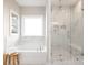 Elegant bathroom featuring a soaking tub and a separate glass-enclosed shower with marble tiles at 13063 Arnold Palmer Cir # 839, Lancaster, SC 29720