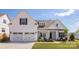 Charming two-story home featuring a two-car garage, landscaped yard, and welcoming front porch at 13063 Arnold Palmer Cir # 839, Lancaster, SC 29720