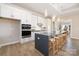 Modern kitchen featuring a spacious island with seating, stainless steel appliances, and white cabinets at 13063 Arnold Palmer Cir # 839, Lancaster, SC 29720