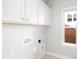 Laundry room features hookups, bright window and storage, offering convenience and natural light at 13063 Arnold Palmer Cir # 839, Lancaster, SC 29720