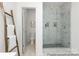 Bathroom featuring a luxurious marble shower, tiled floors, and modern fixtures at 13279 Arnold Palmer Cir # 867, Lancaster, SC 29720