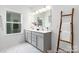 Well-lit bathroom featuring a double vanity, a large mirror, and modern fixtures at 13279 Arnold Palmer Cir # 867, Lancaster, SC 29720