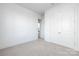Neutral carpet and bright white trim are features of this bedroom with a double door closet at 13279 Arnold Palmer Cir # 867, Lancaster, SC 29720