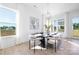 Bright dining area showcasing modern decor, a stylish chandelier, and large windows at 13279 Arnold Palmer Cir # 867, Lancaster, SC 29720
