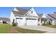 Charming home with a three car garage, stone accents, and a well-maintained lawn at 13279 Arnold Palmer Cir # 867, Lancaster, SC 29720