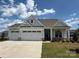 Charming one-story home with a three-car garage and well-manicured lawn at 13279 Arnold Palmer Cir # 867, Lancaster, SC 29720