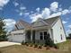 Craftsman-style home featuring a three-car garage, neat landscaping, and a well-maintained lawn at 13279 Arnold Palmer Cir # 867, Lancaster, SC 29720