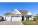 Inviting home showcasing the three car garage and craftsman-style architecture on a sunny day at 13279 Arnold Palmer Cir # 867, Lancaster, SC 29720