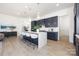 Modern kitchen boasts a large island with bar seating, pendant lights, and sleek countertops at 13279 Arnold Palmer Cir # 867, Lancaster, SC 29720