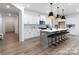 Modern kitchen with gray island, white cabinetry, and pendant lighting at 13279 Arnold Palmer Cir # 867, Lancaster, SC 29720