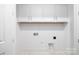 Bright white laundry room featuring upper cabinets and durable marble pattern tile floors at 13279 Arnold Palmer Cir # 867, Lancaster, SC 29720