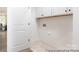 Functional laundry room with white cabinets and light tile flooring, perfect for organization at 13279 Arnold Palmer Cir # 867, Lancaster, SC 29720