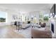 Bright and airy living room with modern furnishings, large windows, and an adjacent dining area at 13279 Arnold Palmer Cir # 867, Lancaster, SC 29720
