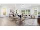 Bright and open living room featuring hardwood floors, neutral tones, and large windows allowing for natural light at 13279 Arnold Palmer Cir # 867, Lancaster, SC 29720